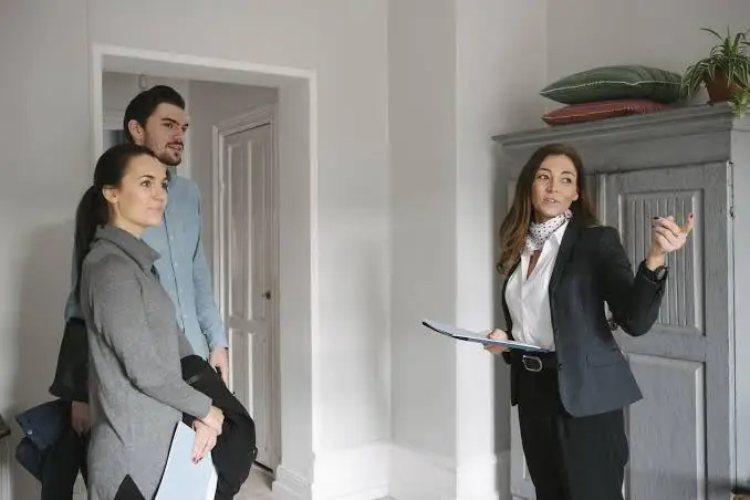 A HomeBliss agent walking buyers through a home