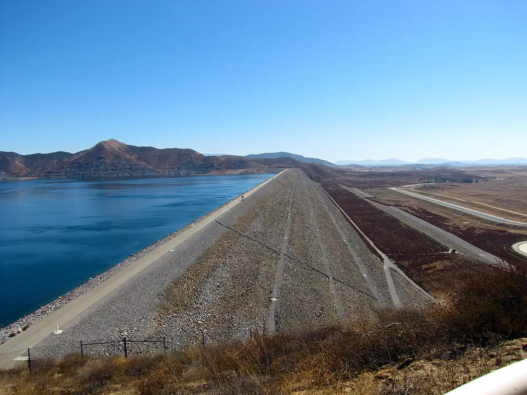The west dam at Diamond Valley Lake near Hemet, California, with the reservoir stretching to the hills