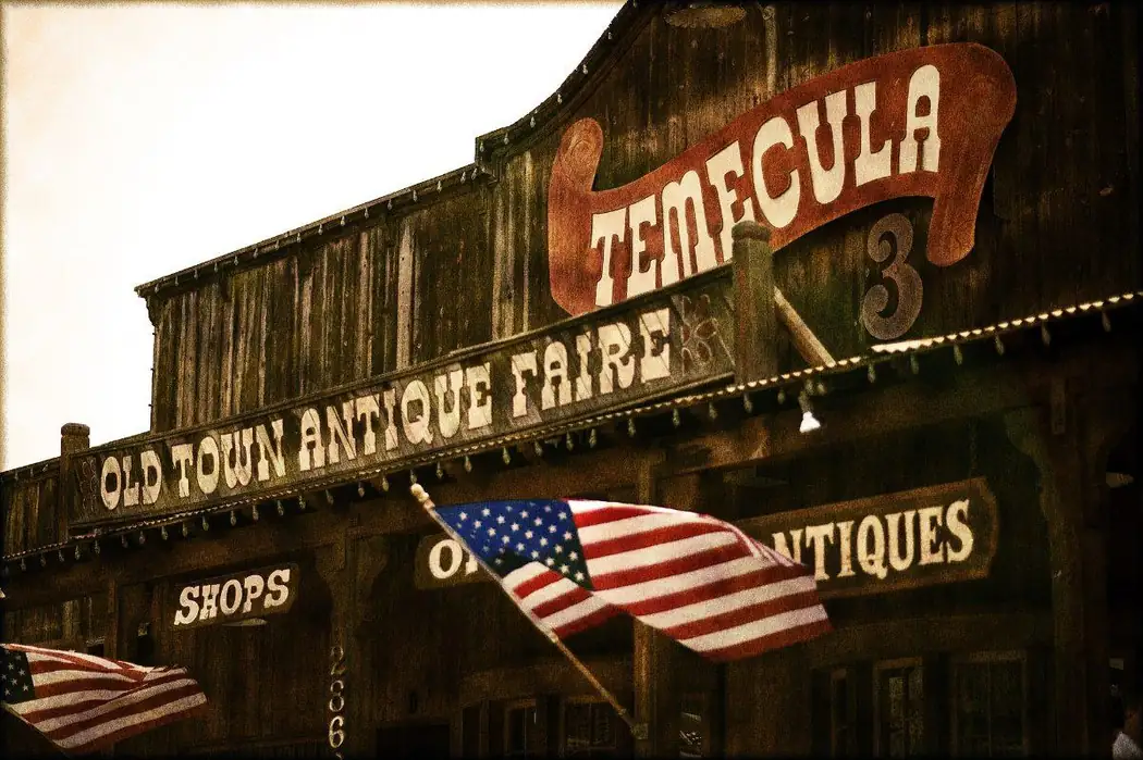 The Old Town Antique Faire sign on a wooden storefront in Old Town Temecula, California