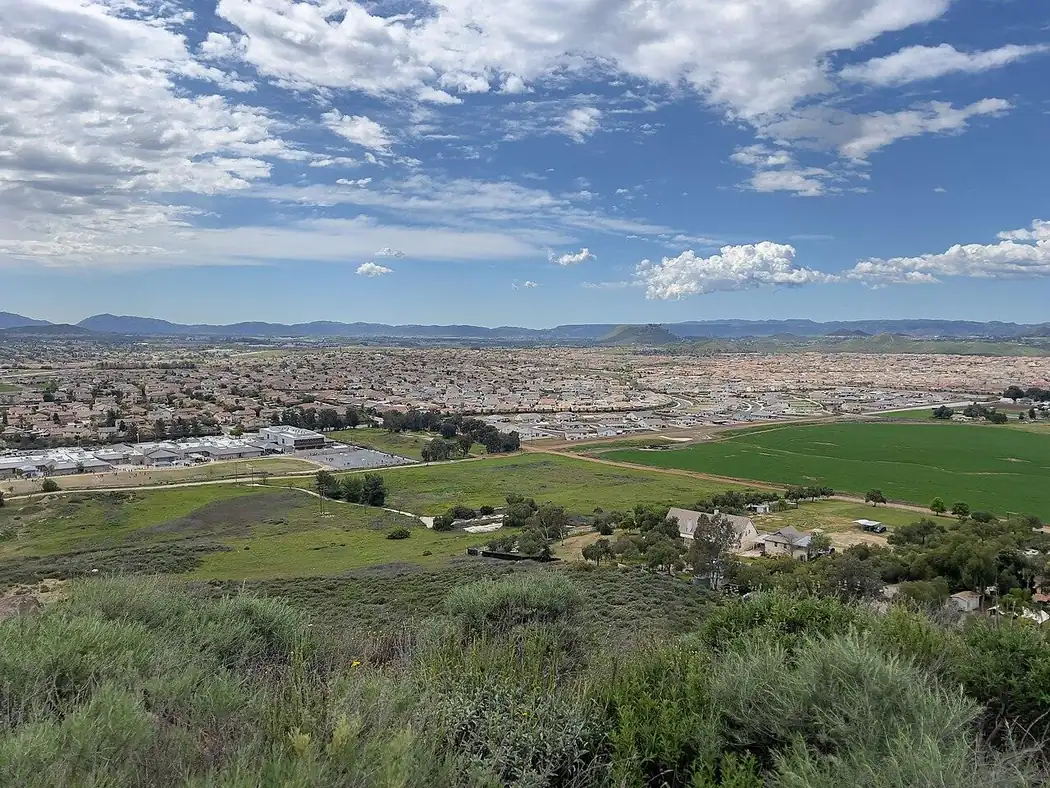 Winchester and French Valley, California, seen from the hills: new neighborhoods spreading across farmland toward the mountains